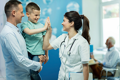 doctor giving high five to little boy
